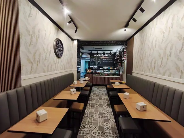 Sala da Docemania no Centro Comercial Maringá, com bancos estofados, papel de parede com espigas e pavimento em mosaico
